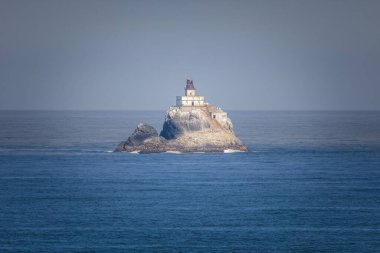 The lighthouse on the Tilamook rock on the coast of Oregon clipart