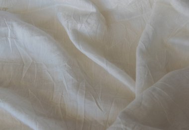 Bej pamuklu, yumuşak desenli giysiler. Tekstil kumaş arkaplanı.