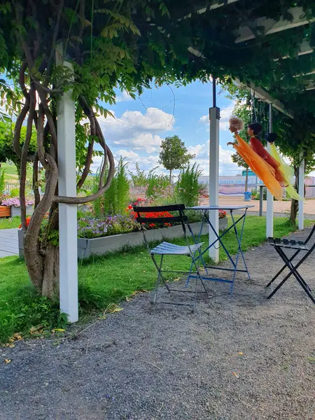 stock image Metal table and chairs for summer rest near the river. Park with panoramic view. 