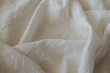 Bej pamuklu, yumuşak desenli giysiler. Tekstil kumaş arkaplanı.