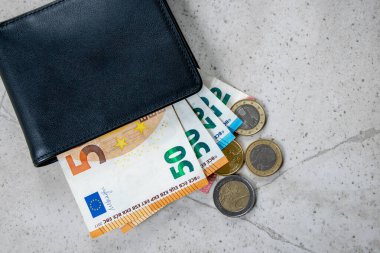 Avrupa parası olan siyah bir parti. Ticaret konsepti için deri cüzdandaki bozukluklar ve faturalar..