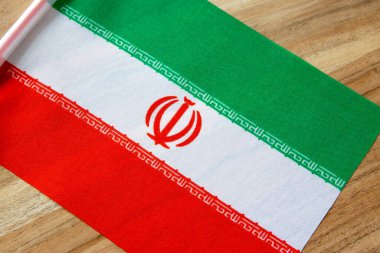 Doğal ahşap arka planda İran bayrağı.