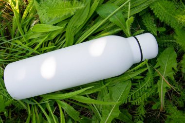 Beyaz termodinamik paslanmaz şişe. Doğada ferahlatıcı su var..