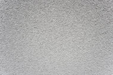 Eski binanın gri taş duvarı eski yapısal alçıdan oluşuyor..