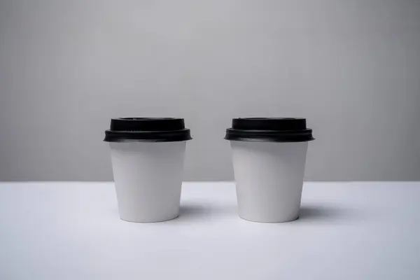 Stock image coffee cups on the white background with shadow.