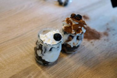 Cam kavanozlarda servis edilen, krema ve malzemelerle kaplanmış, her durum için mükemmel tatlı parfüleri..