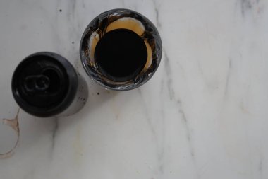 Kapağı açık, koyu bir iç mekanı olan, şık bir mermer arka plana yerleştirilmiş, kahve severler ve mutfak estetiği için ideal bir siyah kahve kutusu..