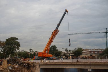 ravine of the destroyed poyo, with machines to begin the reconstruction, produced by DANA of Valencia, in the town of Paiporta on November 12, 2024, with torrential rains clipart