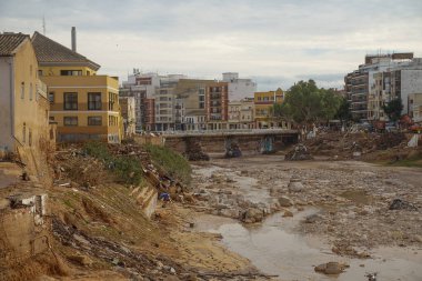 12 Kasım 2024 'te Paiporta kasabasında Valencia' lı DANA tarafından üretilen yeniden yapılanmaya başlayacak makinelerle yıkılmış poyonun geçidi. Şiddetli yağmurlarla birlikte.
