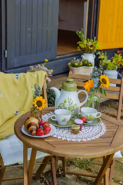 stock image Morning summer tea with flowers and fruits on the veranda in the village house. High quality photo