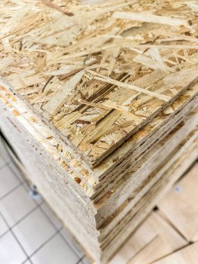 Close-up view of stacked oriented strand board OSB wood sheets for construction. High quality photo clipart