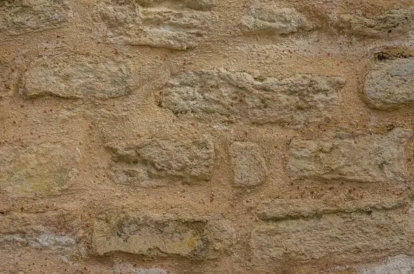 Taş duvar, mimari arka planlar için uygun çeşitli dokulara ve toprak tonlarına sahiptir. Yüksek kalite fotoğraf