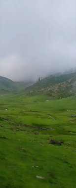 Landscape with clouds. Valley of Flowers, a beautiful Trek in the Himalayas, Nanda Devi Biosphere National Park, amazing landscape, mountains, hills, foggy, misty, Uttarakhand India. clipart