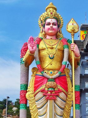 Vibrant Lord Murugan statue adorned with vivid colors, standing tall against a serene background, Salem Tamilnadu.  clipart