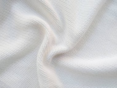 Yün ipliğinden örülmüş giysiler. İplik çerçevesi için yün iplik arkaplanı. El sanatları geçmişi için beyaz örgü ipliği