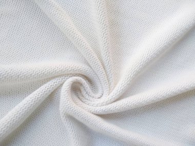 Yün ipliğinden örülmüş giysiler. İplik çerçevesi için yün iplik arkaplanı. El sanatları geçmişi için beyaz örgü ipliği