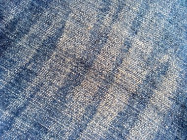 Denim kot kumaşı. Tasarım için Denim arkaplan dokusu. Kumaş kumaş. Arka plan olarak kullanılabilen mavi kot. Herhangi bir arkaplan için mavi kot dokusu