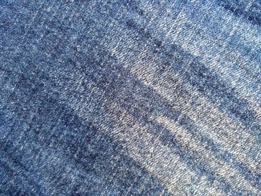 Denim kot kumaşı. Tasarım için Denim arkaplan dokusu. Kumaş kumaş. Arka plan olarak kullanılabilen mavi kot. Herhangi bir arkaplan için mavi kot dokusu