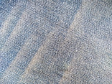 Denim kot kumaşı. Tasarım için Denim arkaplan dokusu. Kumaş kumaş. Arka plan olarak kullanılabilen mavi kot. Herhangi bir arkaplan için mavi kot dokusu