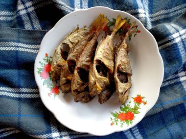 Geleneksel Endonezya mutfağı yemekleri. Ikan Goreng veya kızarmış balık. Ikan Goreng Endonezya yemeği. Basit ve genellikle evde yapılır. Endonezya sokak yiyeceği (kızarmış balık )