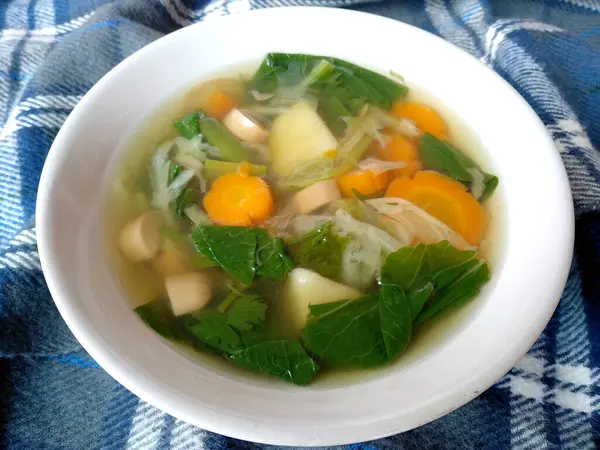 stock image traditional indonesian culinary food. Sayur Bening Dengan Sosis, Kentang, Kol dan Wortel or green vegetables with Sausages, Potatoes, Cabbage and Carrots. Sayur Bening Indonesian Food