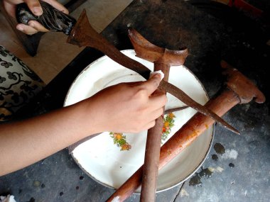 Cleaning the Keris. Keris is Indonesian traditional weapon. Made manually by using the selected iron. The handle is made of wood or ivory. ( Old Balinese keris ) clipart