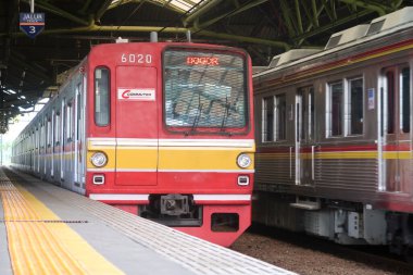 Indonesian Commuter Trains (KRL / Commuter Line) pass Gambir Train Station, Jakarta clipart