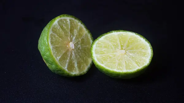 stock image Kaffir Lime or Citrus hystrix that has been sliced. Focus selected, black background