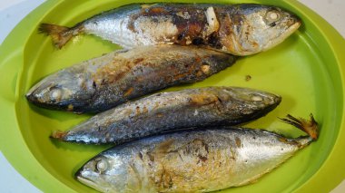 Kızardıktan sonra yeşil bir tabakta Pindang balığı servis edilir. Kapat, seçili odaklan