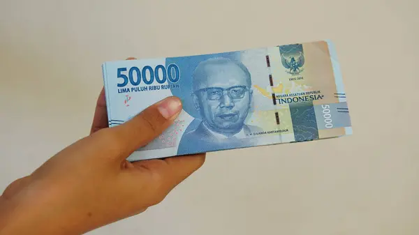 stock image Indonesian rupiah banknote, 50,000 rupiah, held by woman
