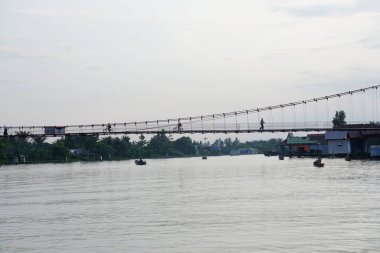 Martapura River with a small bridge over it clipart