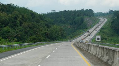 Trans Java toll road KM 449 at noon clipart