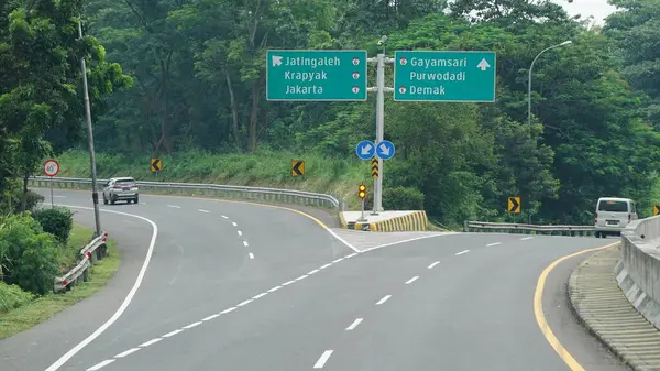 stock image Trans Java toll road at noon. There are signs for the city of Jakarta, Purwodadi, Demak