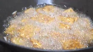 Kızarmış tempeh tavada kızartılıyor. Seçilene odaklan