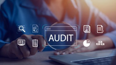 İşadamı, iç mali hesapları denetlemek ve şirketin mali durumunu değerlendirmek için dizüstü bilgisayar kullanıyor..