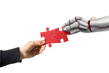 İnsan ve robot eli bulmaca parçasını birbirine bağlıyor. Beyazda izole edilmiş.