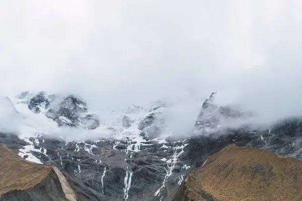 stock image humantay lagoon in the andes mountain range of peru cusco surrounded by snow capped mountains with clouds