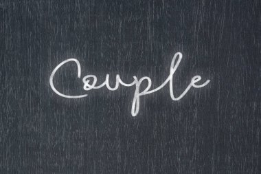 A blackboard with a handwritten chalk message that says couple, a powerful symbol of business success and motivation in educational and production concepts.
