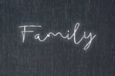 A blackboard with a handwritten chalk message that says family, a powerful symbol of business success and motivation in educational and production concepts.