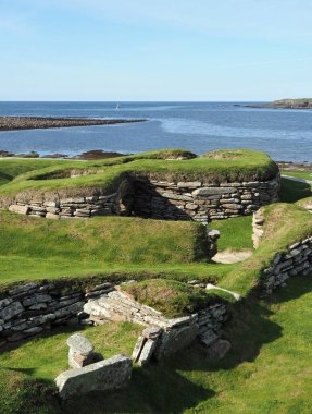 Skara Brae Neolithic settlement. Bay of Skaill. Ornkey Islands. Scotland. Skara Brae is a stone-built Neolithic settlement, located in the Orkney archipelago. It is one of the best preserved groups of prehistoric houses in Europe. clipart