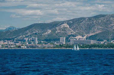 Gök mavisi Akdeniz 'deki yelkenli Marsilya siluetine karşı