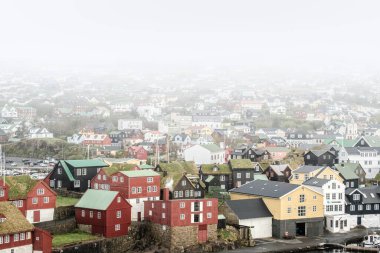 Misty morning over the colorful cityscape of Thorshavn, Faroe Islands.
