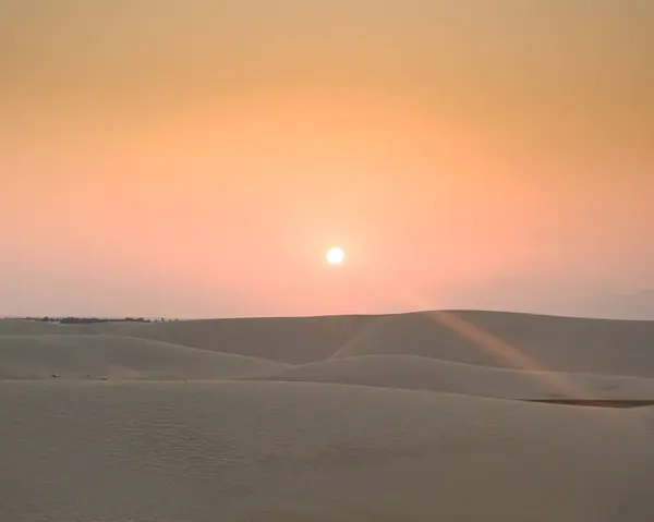 stock image Sunrise over the stunning Zahek Dunes in Socotra, Yemen, casting a serene glow over the vast desert landscape