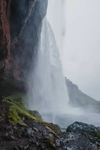 stock image View from behind Seljalandsfoss waterfall in Iceland