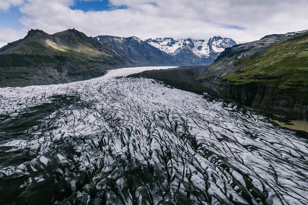 Dramatic view of Svinafellsjokull glacier with icy patterns and glacial pools, South Iceland