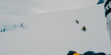 Snowmobiling on Langjokull Glacier in South Iceland, exploring icy wilderness clipart