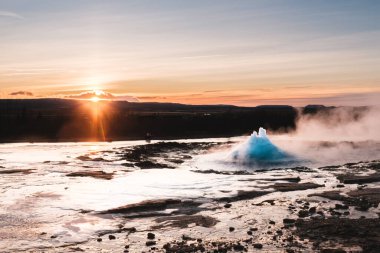 Strokkur Geysir eruption at sunset in south Iceland, Haukadalur valley clipart