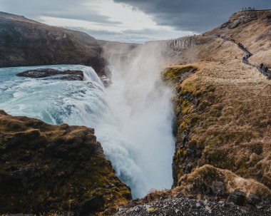 Breathtaking view of Gullfoss waterfall plunging into a deep canyon in south Iceland. clipart