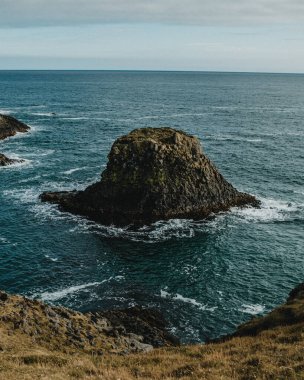 Lone basalt sea stack off the coast of Arnarstapi, Snaefellsnes Peninsula, West Iceland clipart