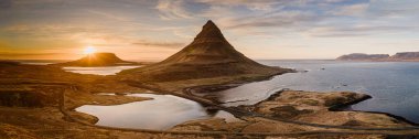 Kirkjufell mountain at sunset with scenic coastal landscape in Snaefellsnes Peninsula, West Iceland. clipart